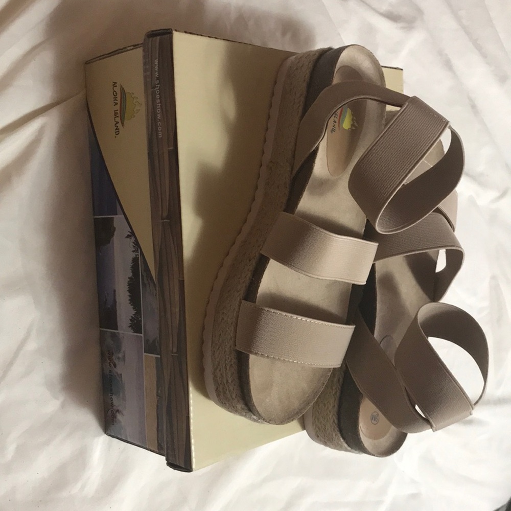 These are some cream colored flat form sandals.